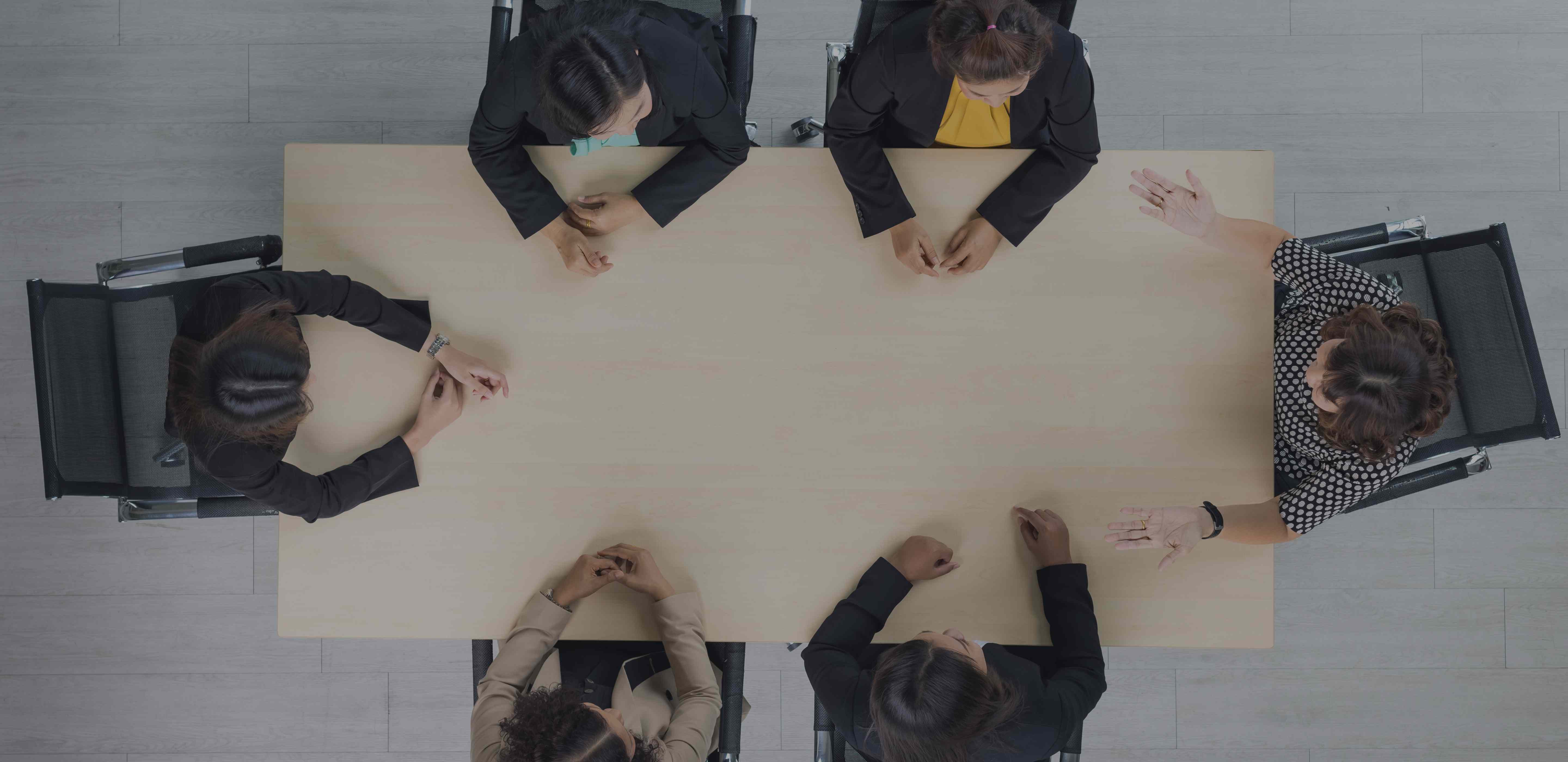 Strategic Gears team collaboration - overhead view of professionals working together around conference table